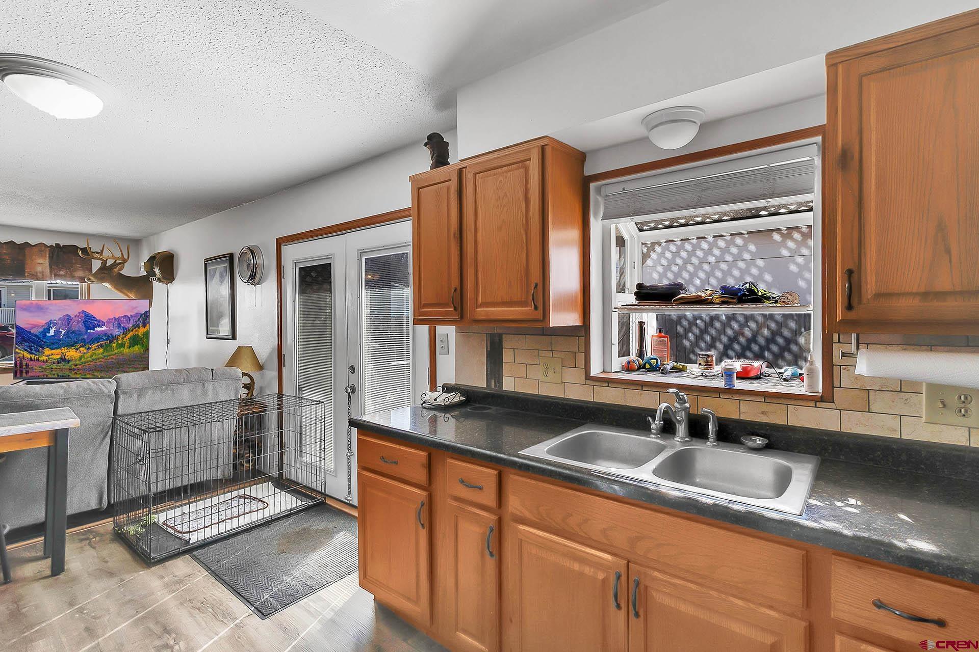 1011 Ray Avenue Delta, CO 81416 - Photo 11 of 26 a kitchen with granite countertop a sink stainless steel appliances and cabinets