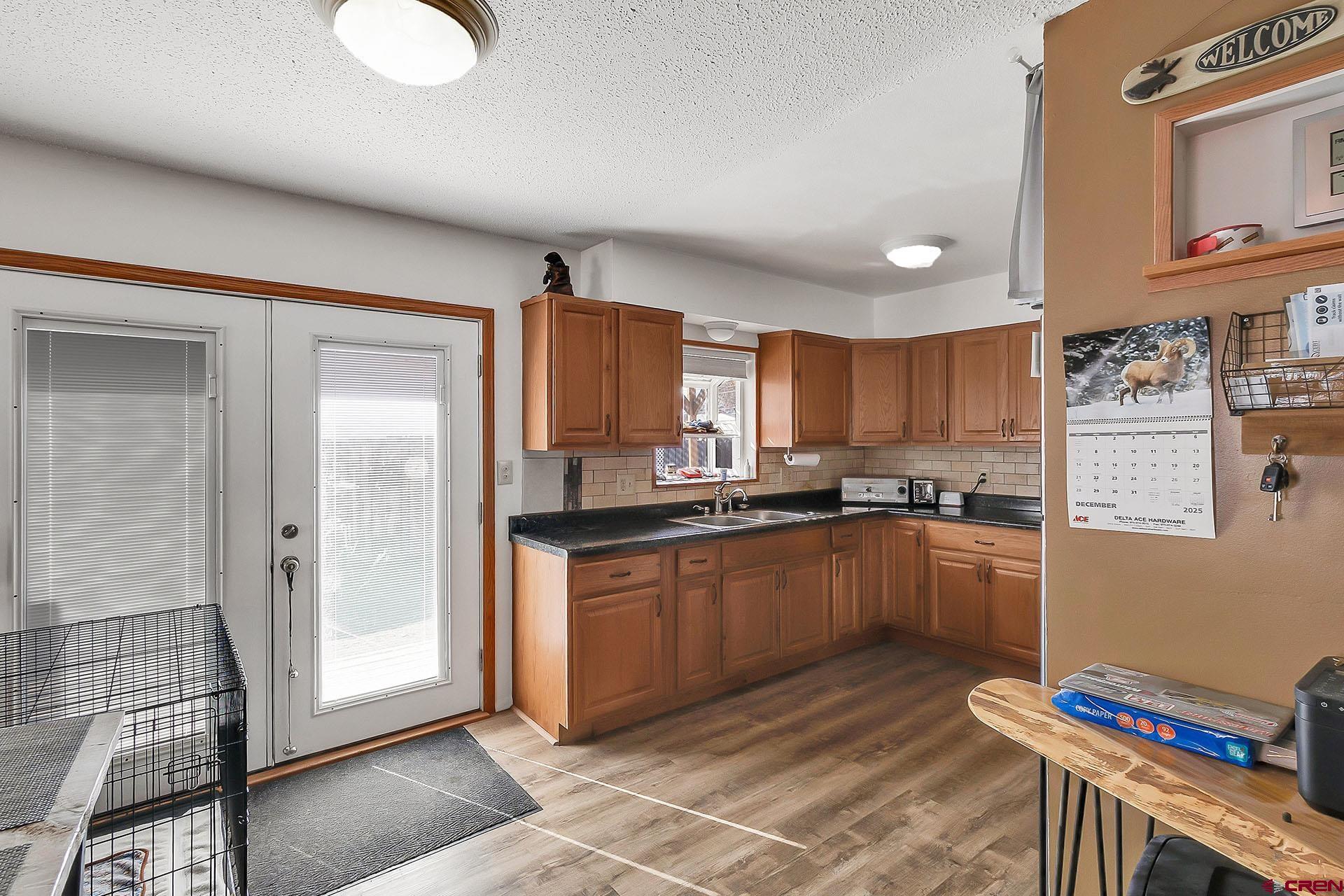 1011 Ray Avenue Delta, CO 81416 - Photo 13 of 26 a kitchen with stainless steel appliances granite countertop a refrigerator and a stove top oven