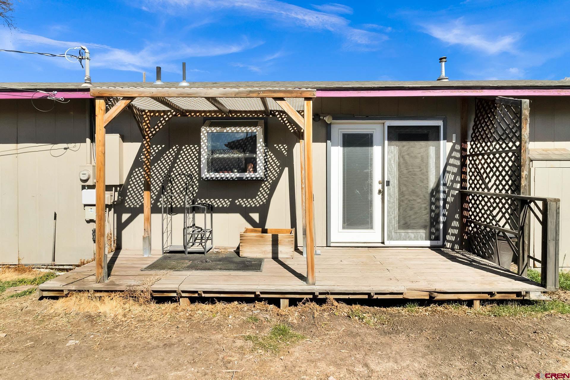 1011 Ray Avenue Delta, CO 81416 - Photo 24 of 26 a view of a house with a wooden fence
