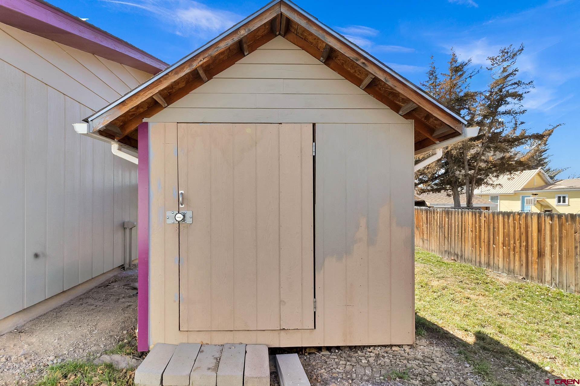 1011 Ray Avenue Delta, CO 81416 - Photo 25 of 26 a front view of a house with garden