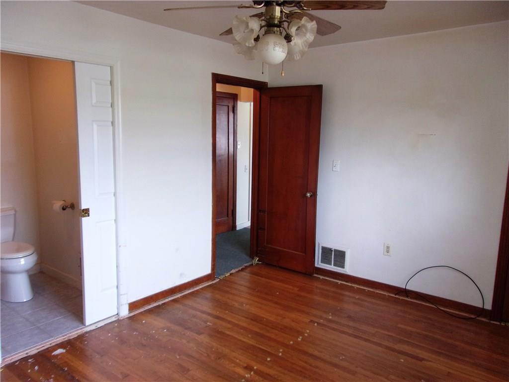 2288 Reis Run Road Pittsburgh, PA 15237 - Photo 18 of 23 Second bedroom (carpeting was pulled up..can be redone or carpeted), pocket door to left is to accessible shower and toilet.