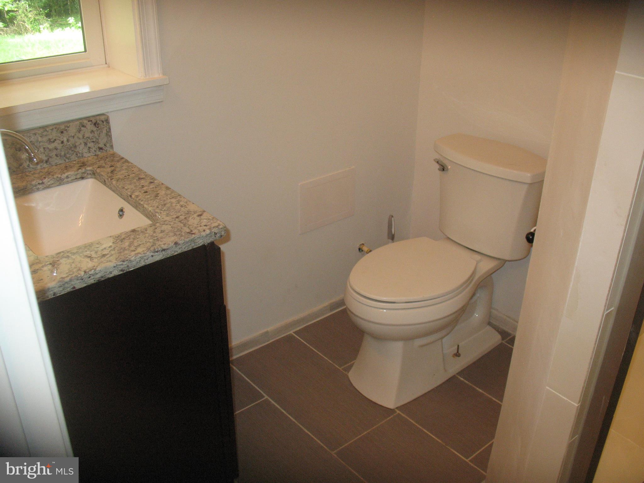 5110 Sharon Road Temple Hills, MD 20748 - Photo 23 of 30 bathroom with ceramic tile~floor in basement
