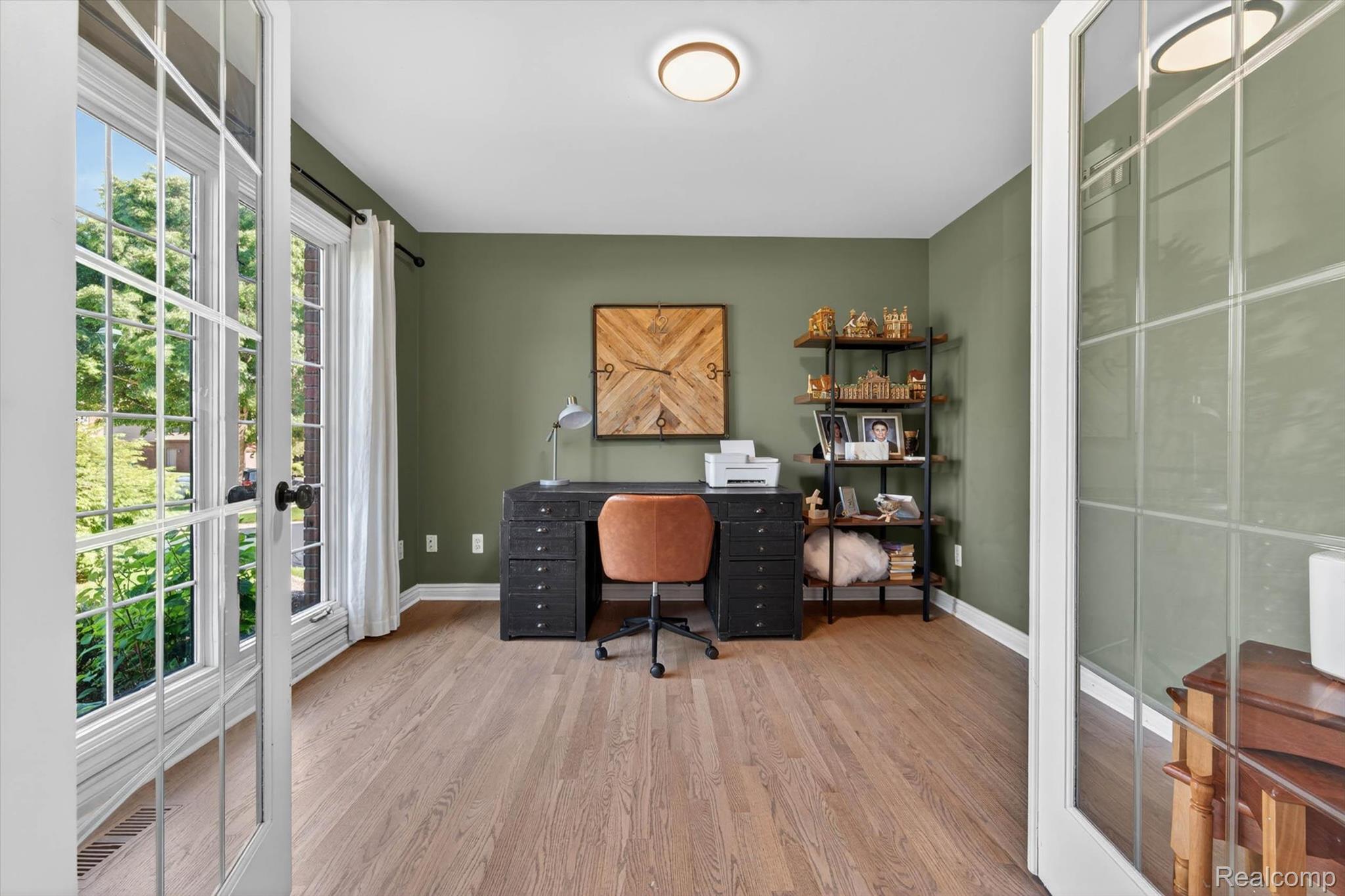 371 Lone Pine Circle Rochester, MI 48307 - Photo 8 of 59 Room featuring hardwood flooring, olive-toned walls, and a contemporary flush-mount ceiling light