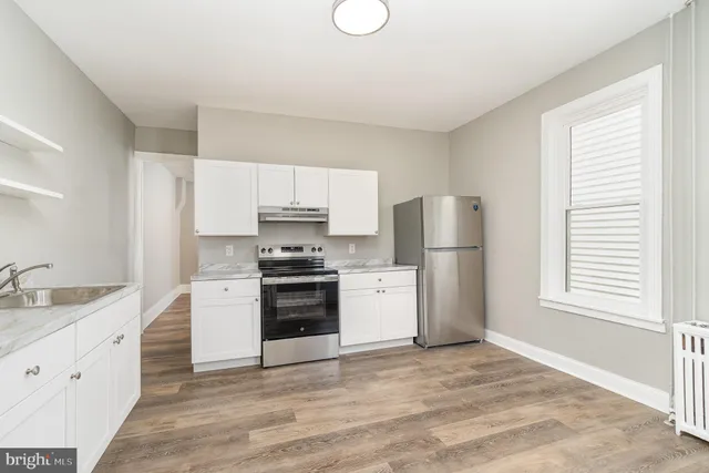 a kitchen with a refrigerator stove and sink