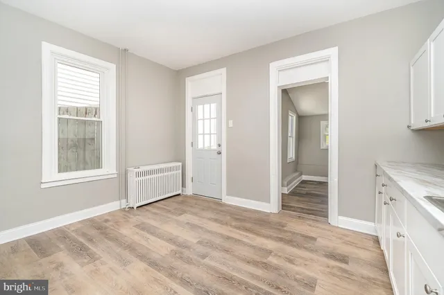 an empty room with windows and closet