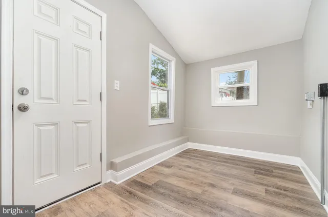 an empty room with windows and closet