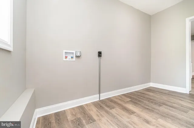 a view of a room with wooden floor and window