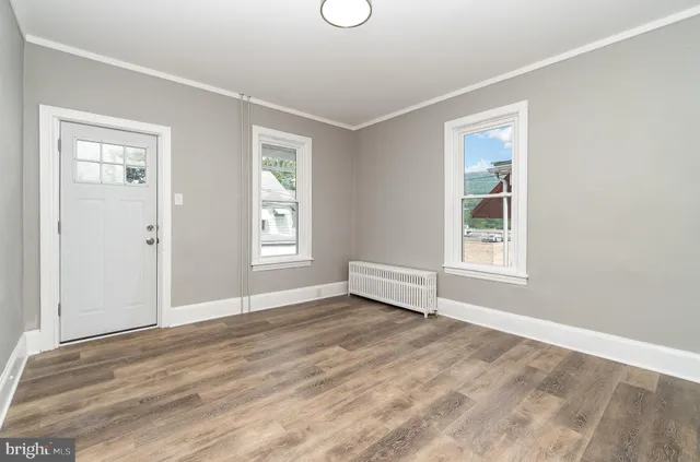 an empty room with windows and closet