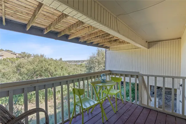 a view of a balcony with wooden floor