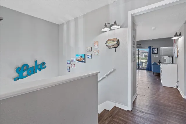 a hallway with painting and wooden floor