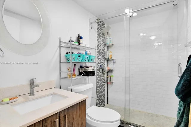 a bathroom with a sink toilet and shower