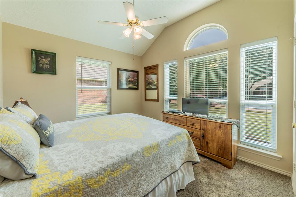 1013 Short Line Boulevard Midlothian, TX 76065 - Photo 13 of 26 a bedroom with a bed dresser and a window