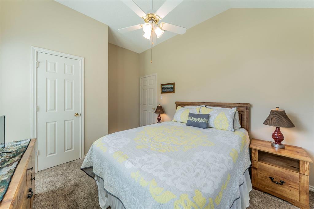 1013 Short Line Boulevard Midlothian, TX 76065 - Photo 14 of 26 a bedroom with a bed and a chandelier