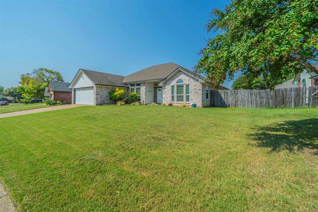 1013 Short Line Boulevard Midlothian, TX 76065 - Photo 19 of 26 a white house with a big yard and large trees with wooden fence