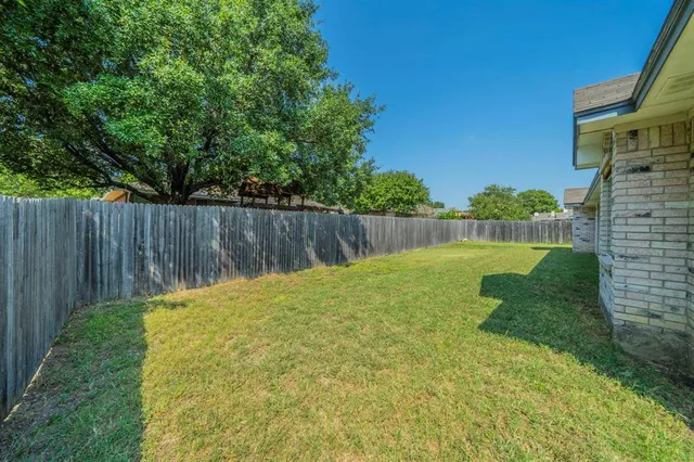 a view of a house with a yard and garage