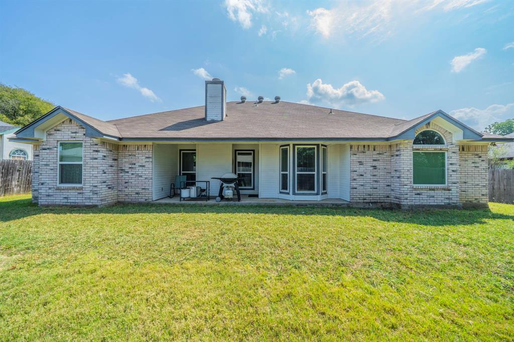 1013 Short Line Boulevard Midlothian, TX 76065 - Photo 24 of 26 a front view of a house with a garden and patio