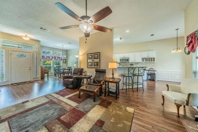 a living room with lots of furniture and kitchen view