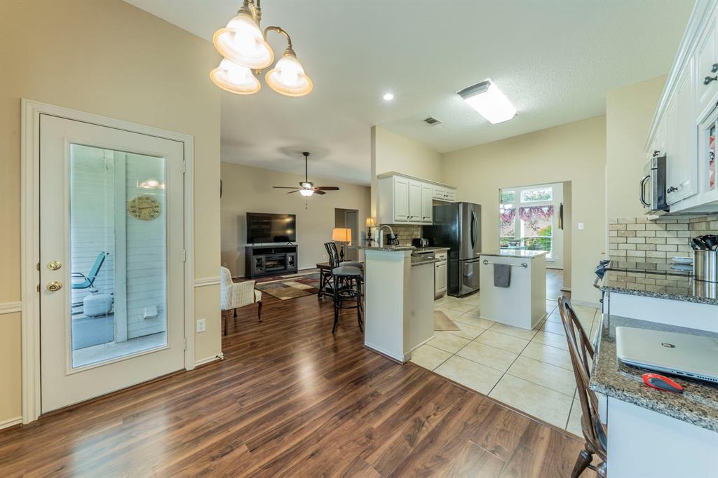 1013 Short Line Boulevard Midlothian, TX 76065 - Photo 25 of 26 a view of a kitchen and dining room with wooden floor
