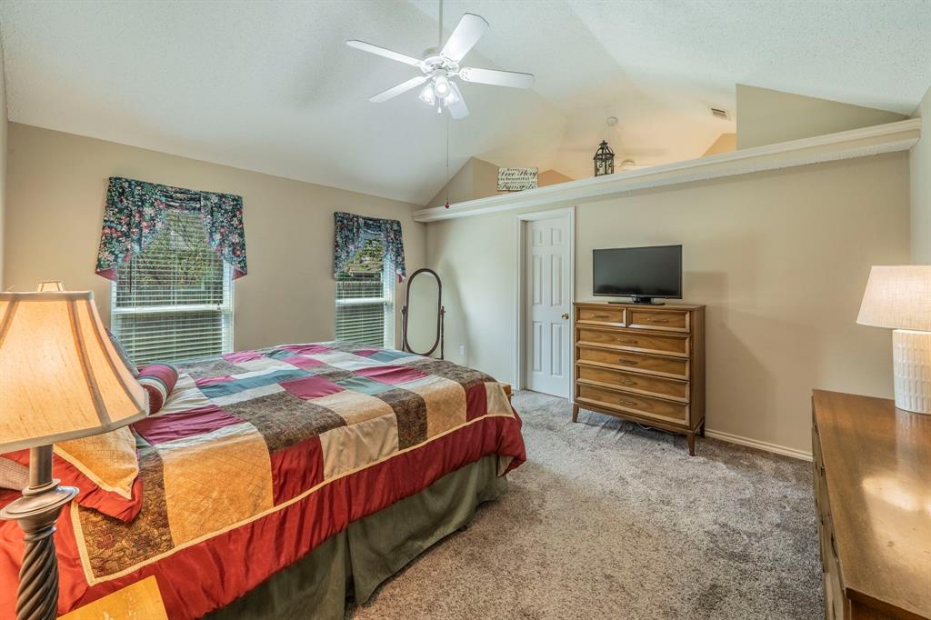 1013 Short Line Boulevard Midlothian, TX 76065 - Photo 9 of 26 a bedroom with a bed closet and a flat tv screen