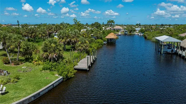 an aerial view of a residential houses with outdoor space and river