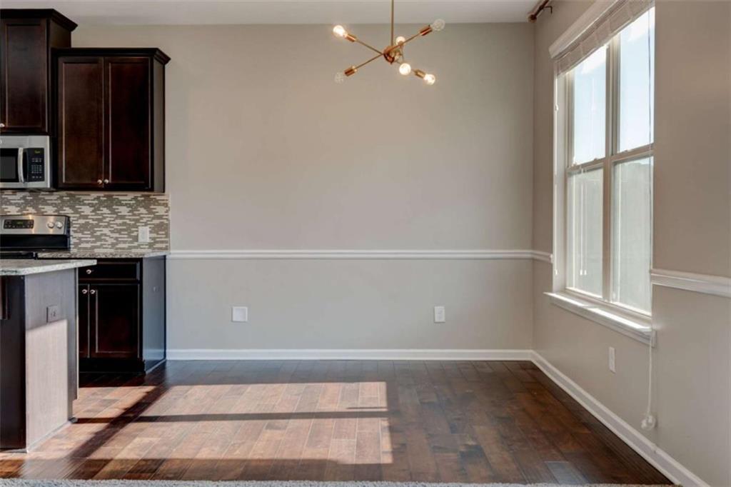 7601 Summer Berry Lane Lithonia, GA 30038 - Photo 12 of 34 wooden floor in an empty room with a window