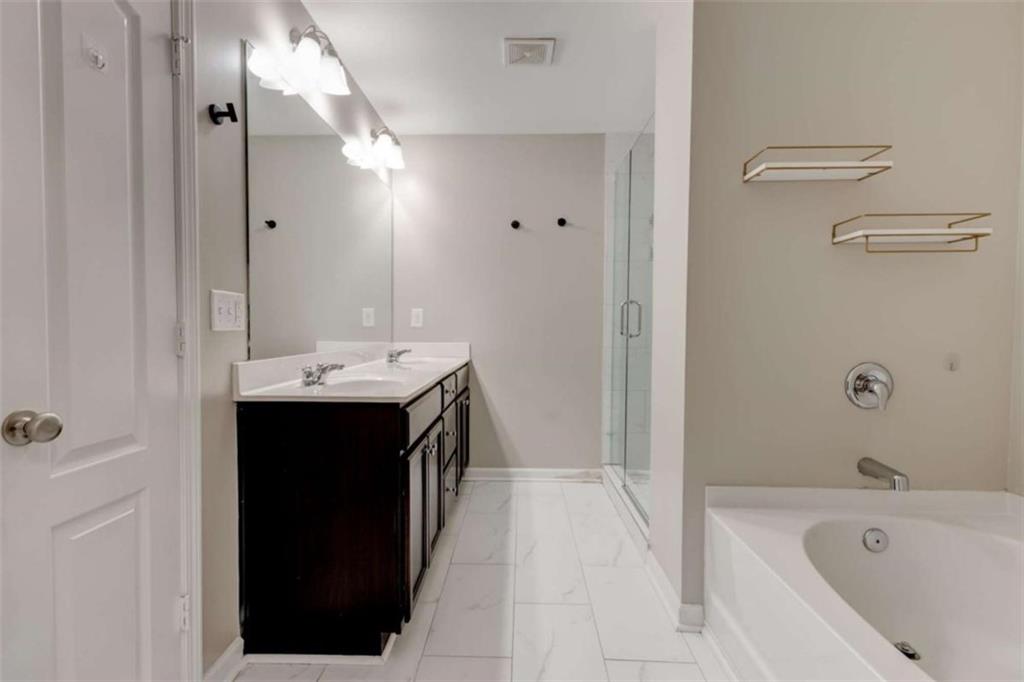 7601 Summer Berry Lane Lithonia, GA 30038 - Photo 24 of 34 a bathroom with a tub sink vanity and a mirror