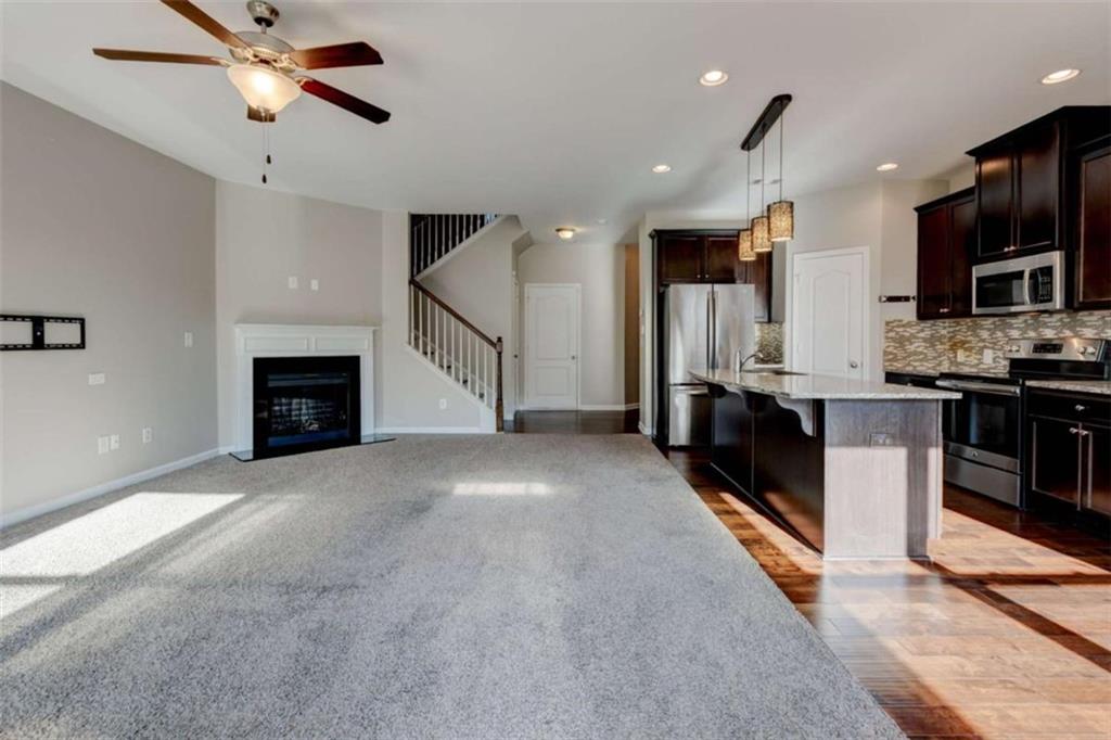7601 Summer Berry Lane Lithonia, GA 30038 - Photo 8 of 34 a view of a kitchen with microwave and a stove