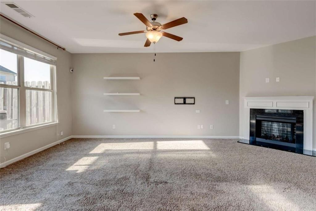 7601 Summer Berry Lane Lithonia, GA 30038 - Photo 9 of 34 a view of an empty room with a fireplace and a window