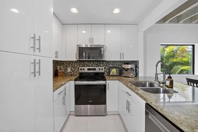 a view of a room with furniture and a flat screen tv