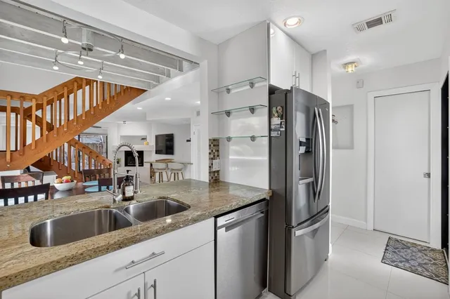 a spacious bedroom with a large bed and a flat tv