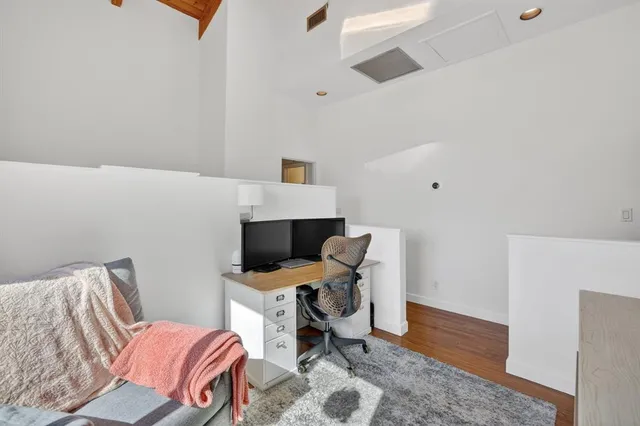 a view of balcony with wooden floor and outdoor seating