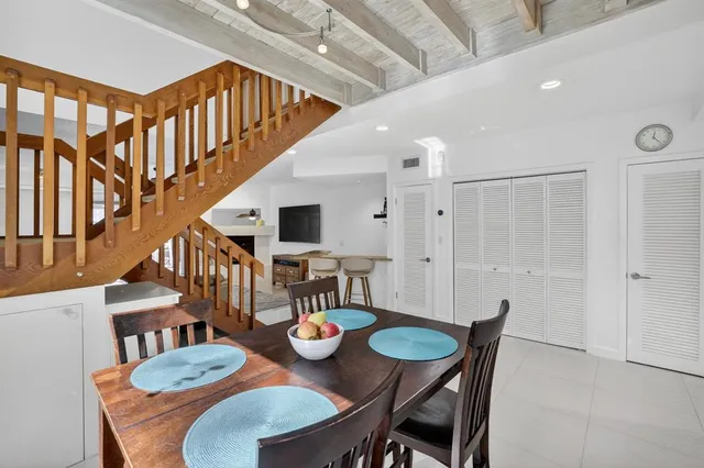 a living room with furniture a ceiling fan and a fireplace