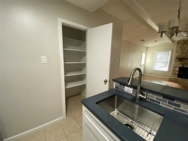 a kitchen with a sink and a stove top oven
