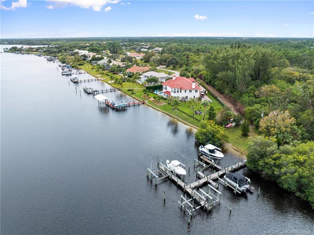 12038 Riverbend Road Port St. Lucie, FL 34984 - Photo 21 of 86 an aerial view of a house with a lake view