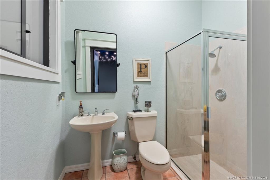 12038 Riverbend Road Port St. Lucie, FL 34984 - Photo 28 of 86 a bathroom with a toilet sink and shower