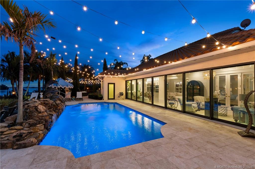 12038 Riverbend Road Port St. Lucie, FL 34984 - Photo 32 of 86 a view of a swimming pool with seating area