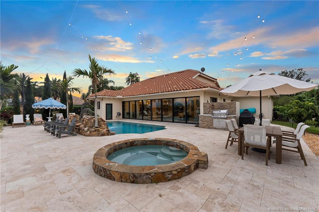 12038 Riverbend Road Port St. Lucie, FL 34984 - Photo 36 of 86 a view of a house with swimming pool and sitting area