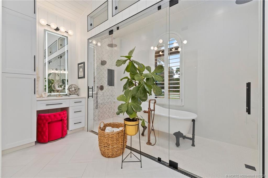 12038 Riverbend Road Port St. Lucie, FL 34984 - Photo 54 of 86 a dining room with chandelier fan and wooden floor