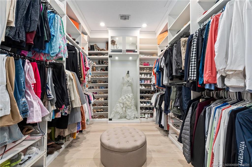 12038 Riverbend Road Port St. Lucie, FL 34984 - Photo 56 of 86 a view of walk in closet with clothes and shoes