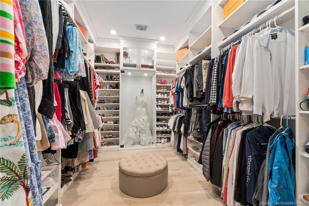 12038 Riverbend Road Port St. Lucie, FL 34984 - Photo 57 of 86 a view of walk in closet with clothes and shoes