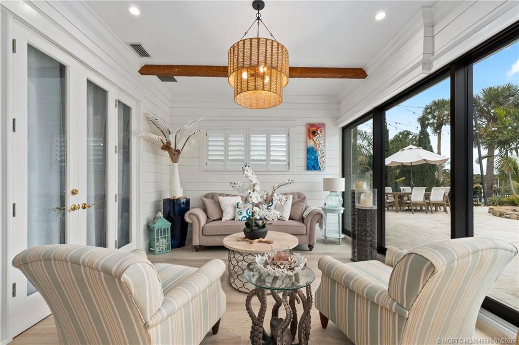 12038 Riverbend Road Port St. Lucie, FL 34984 - Photo 62 of 86 a living room with furniture chandelier and a large window