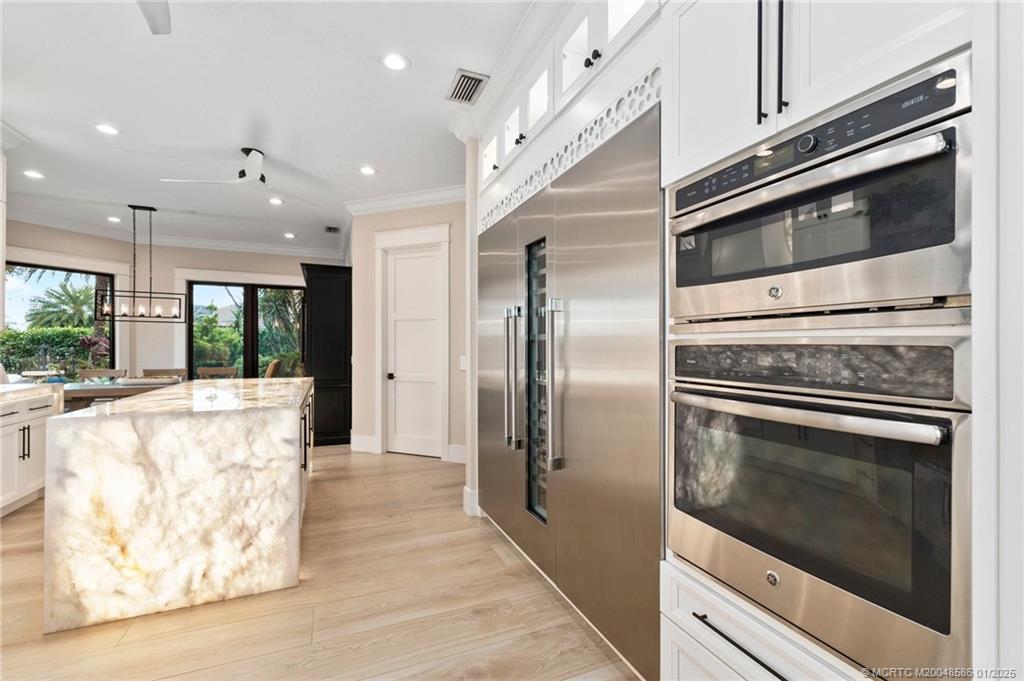 12038 Riverbend Road Port St. Lucie, FL 34984 - Photo 65 of 86 a kitchen with stainless steel appliances granite countertop a refrigerator and a stove