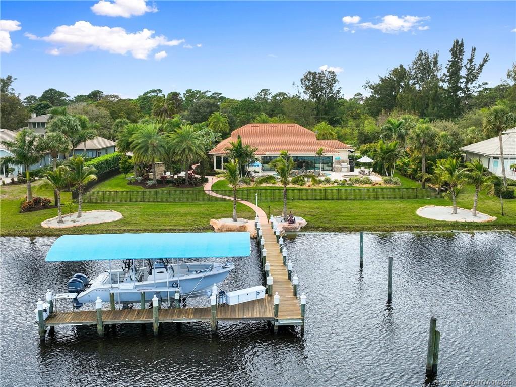 12038 Riverbend Road Port St. Lucie, FL 34984 - Photo 7 of 86 a view of a yard with a table and chairs