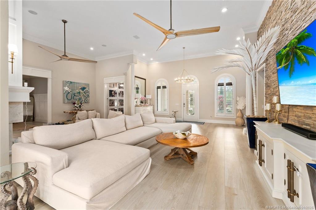 12038 Riverbend Road Port St. Lucie, FL 34984 - Photo 76 of 86 a living room with furniture a rug kitchen view and a chandelier