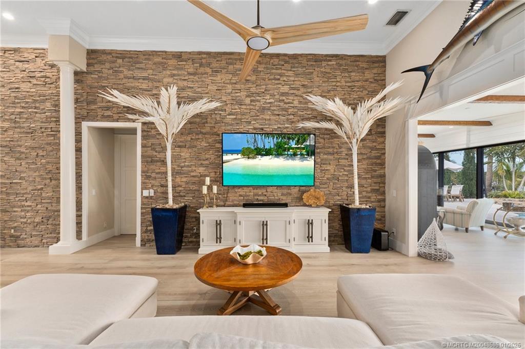 12038 Riverbend Road Port St. Lucie, FL 34984 - Photo 78 of 86 a living room with furniture and a flat screen tv