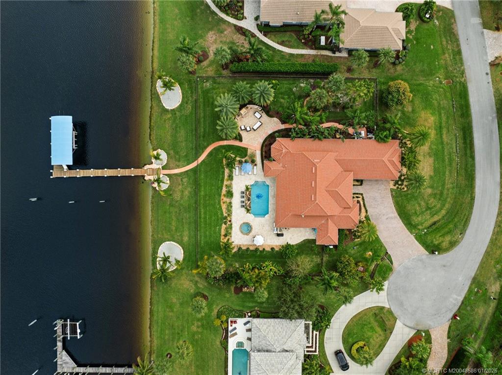12038 Riverbend Road Port St. Lucie, FL 34984 - Photo 8 of 86 an aerial view of a house with outdoor space pool seating area and yard