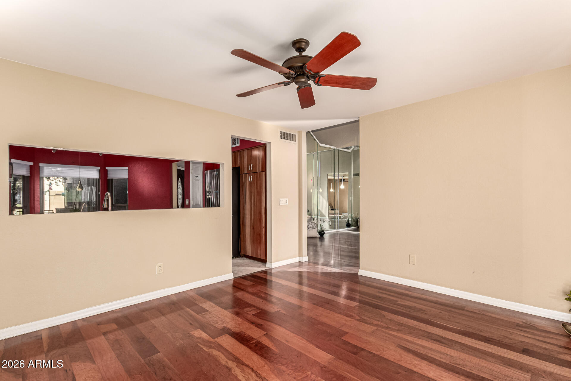 4279 East Agave Road Phoenix, AZ 85044 - Photo 11 of 31 a view of a living room with wooden floor and ceiling fan