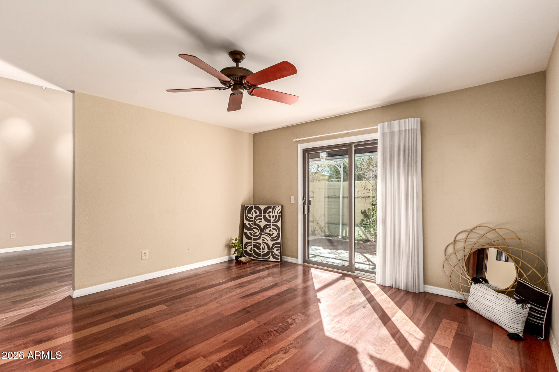 4279 East Agave Road Phoenix, AZ 85044 - Photo 12 of 31 a view of a room with wooden floor fan and windows