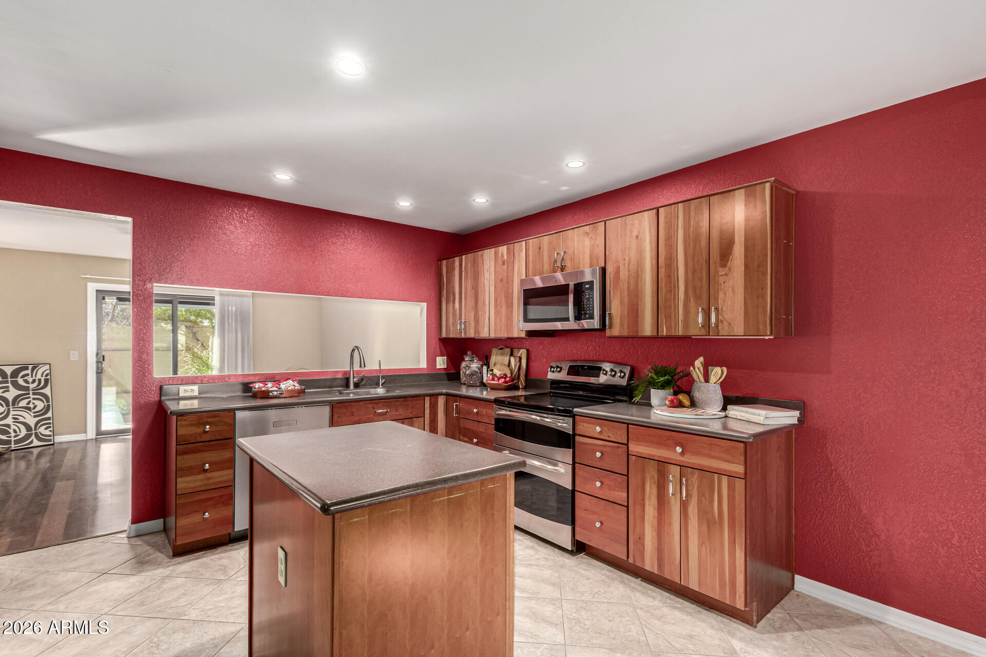4279 East Agave Road Phoenix, AZ 85044 - Photo 14 of 31 a kitchen with a stove a sink a refrigerator and cabinets