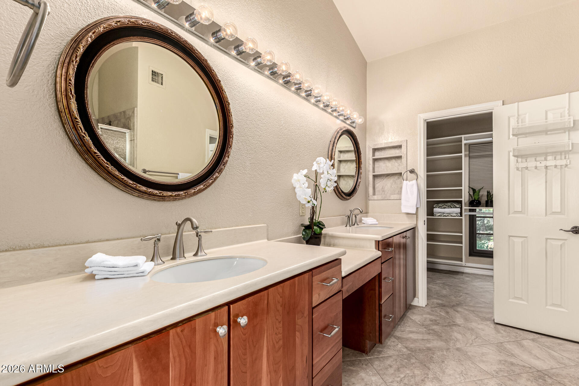 4279 East Agave Road Phoenix, AZ 85044 - Photo 19 of 31 a spacious bathroom with a double vanity sink and a mirror